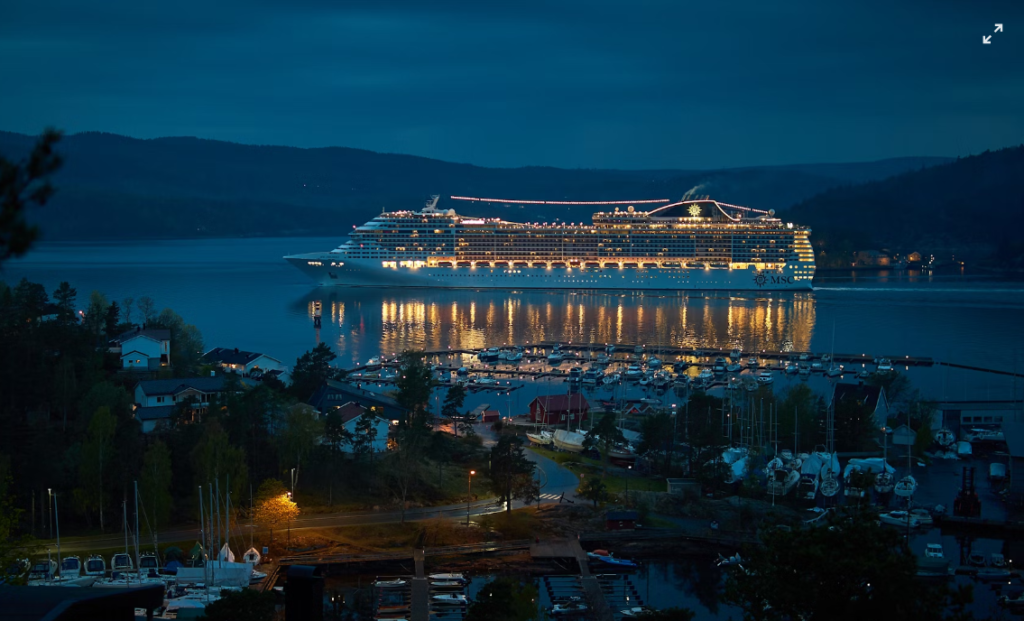 a picture of a cruise ship at night with lights
